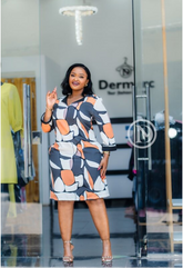 Vibrant black, white, and orange abstract shift dress.